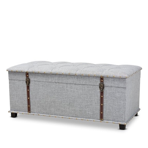 Kyra grey fabric upholstered storage trunk ottoman.