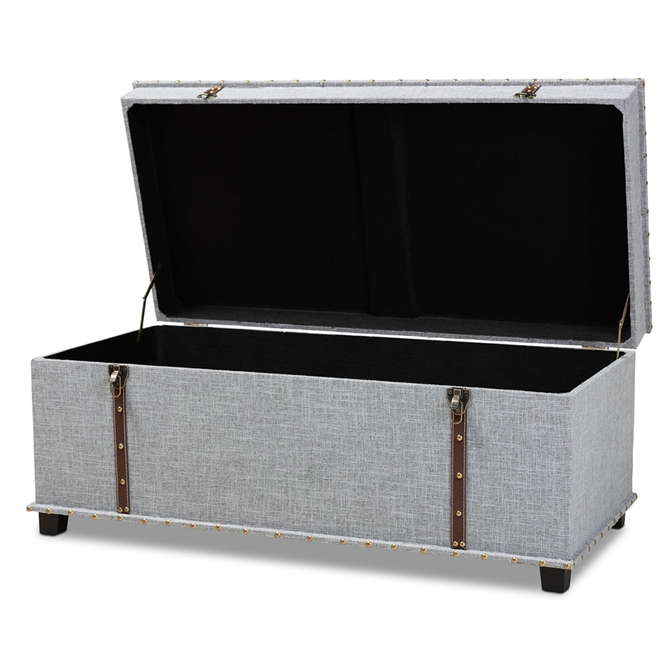 Kyra grey fabric upholstered storage trunk ottoman.