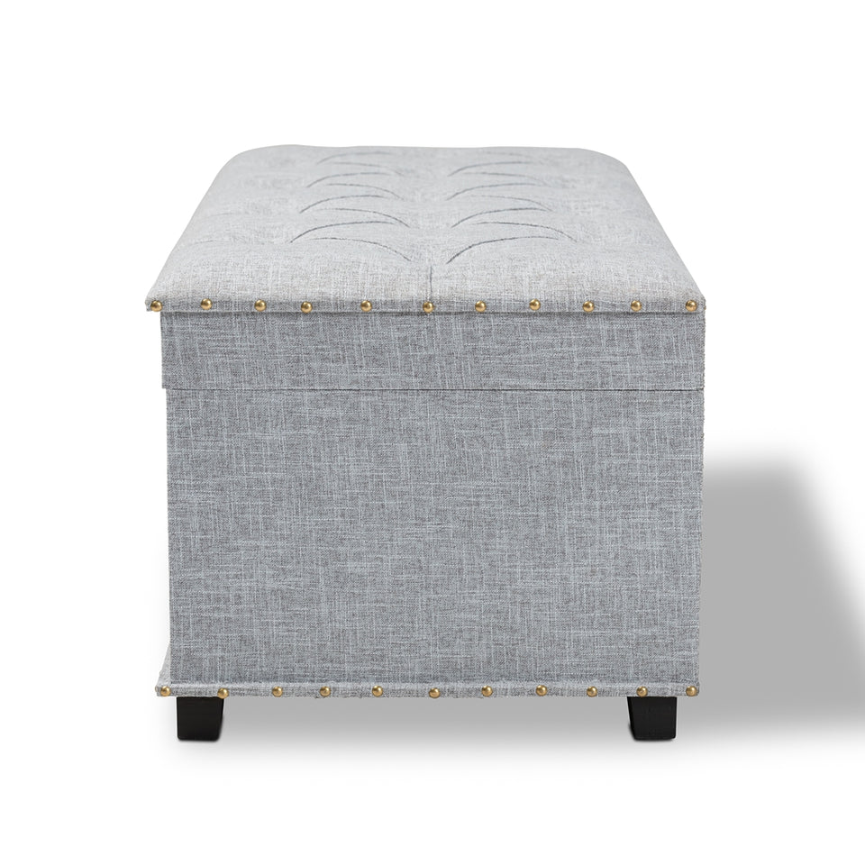 Kyra grey fabric upholstered storage trunk ottoman.