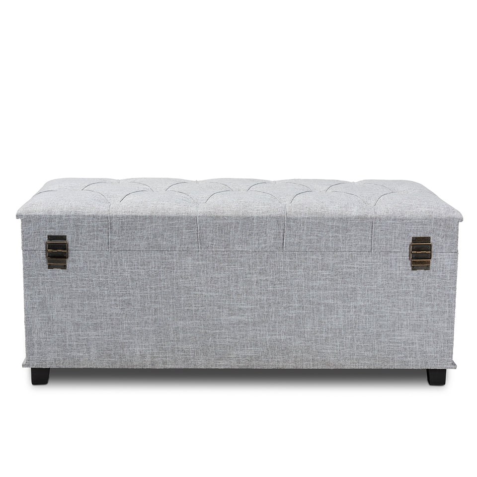 Kyra grey fabric upholstered storage trunk ottoman.