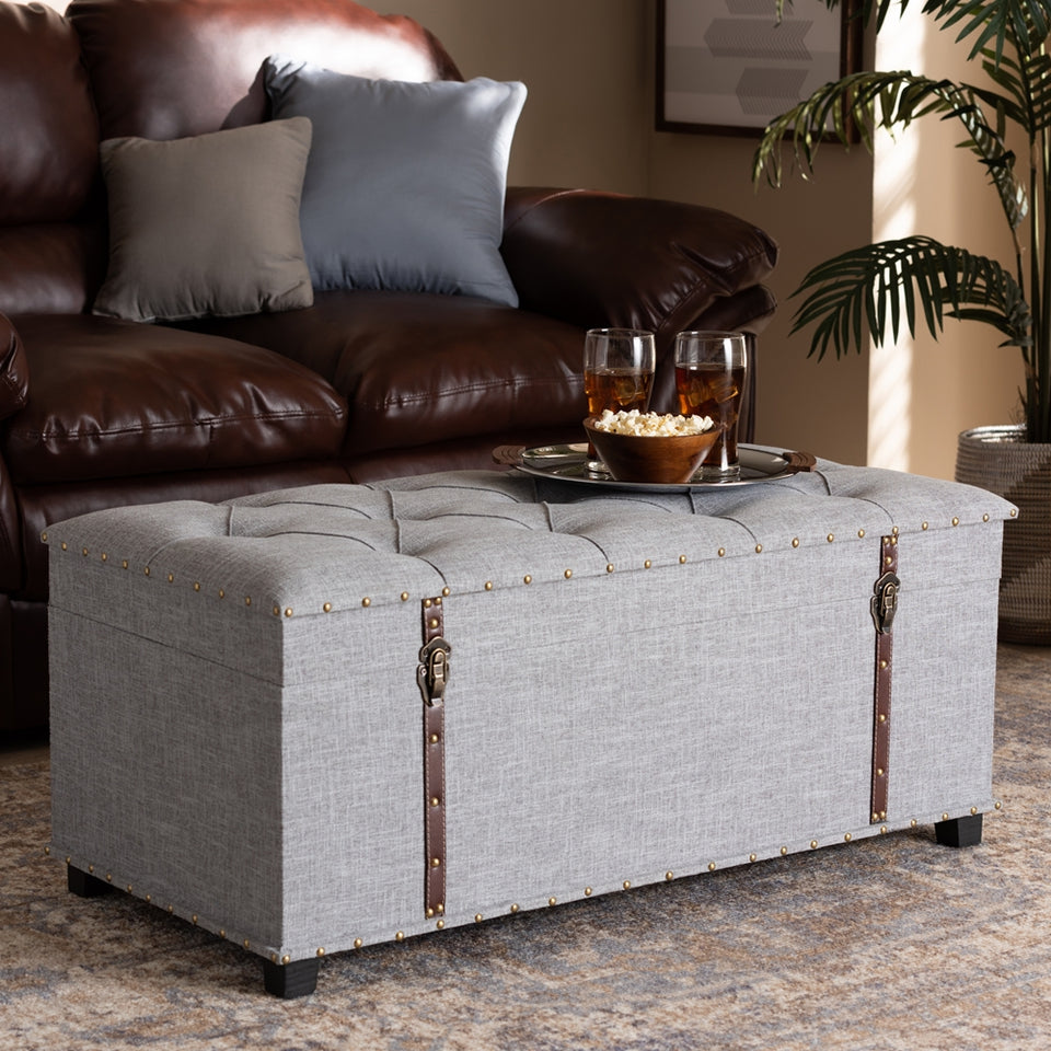 Kyra grey fabric upholstered storage trunk ottoman.