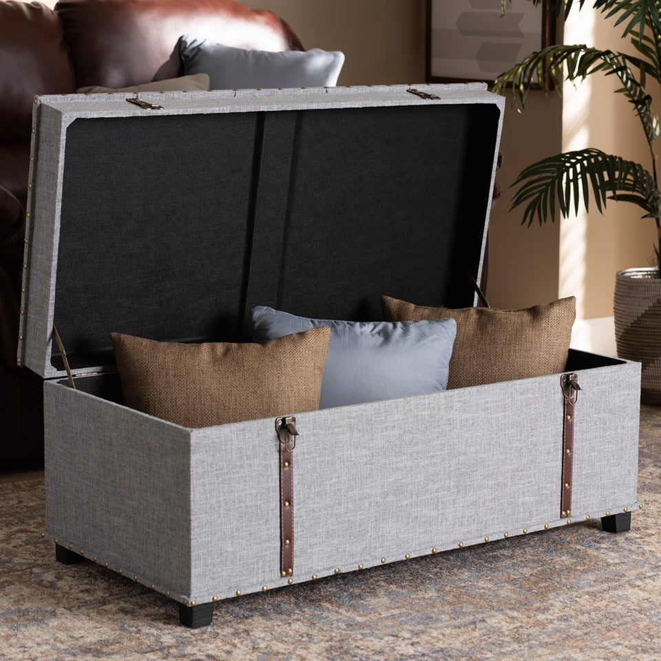 Kyra grey fabric upholstered storage trunk ottoman.