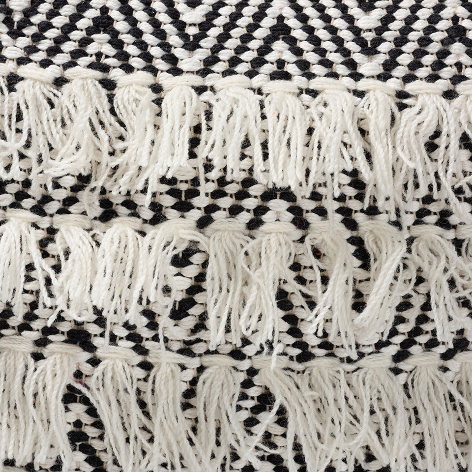 Alain Moroccan inspired black and ivory handwoven wool tassel pouf ottoman.