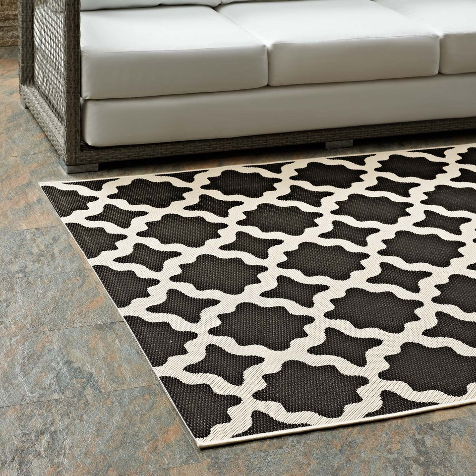 Cerelia Moroccan Trellis Indoor and Outdoor Area Rug in Black and Beige.