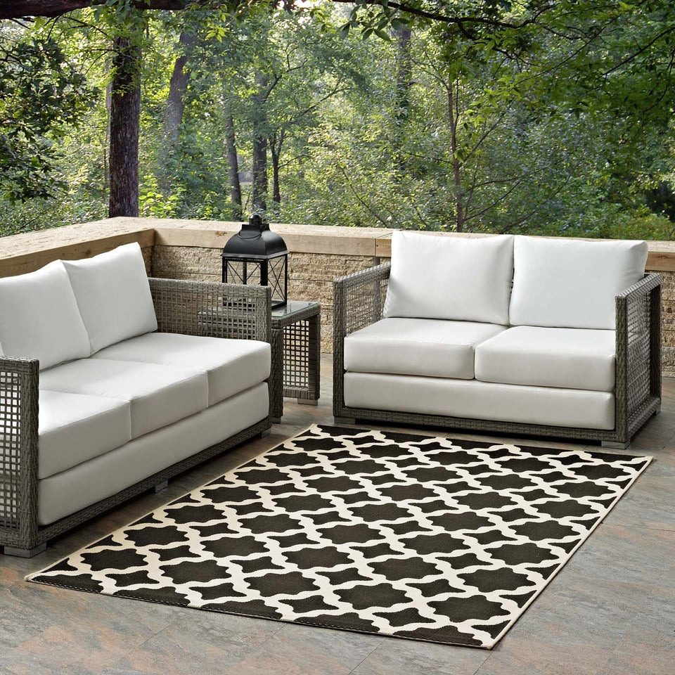 Cerelia Moroccan Trellis Indoor and Outdoor Area Rug in Black and Beige.