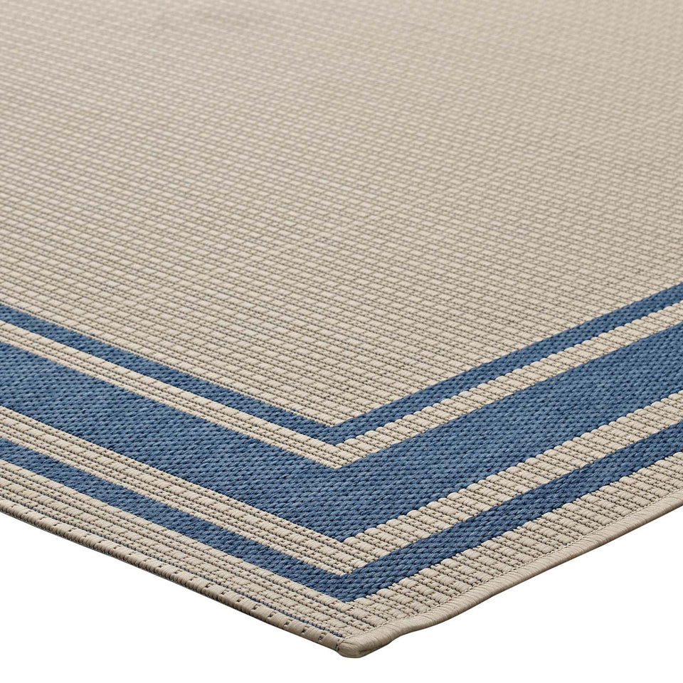 Rim Solid Border Indoor and Outdoor Area Rug in Blue and Beige.